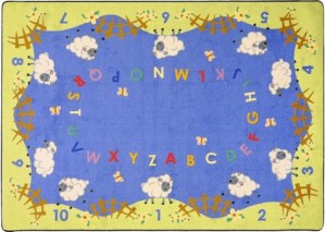 An alphabet rug with numbers and several lamb.