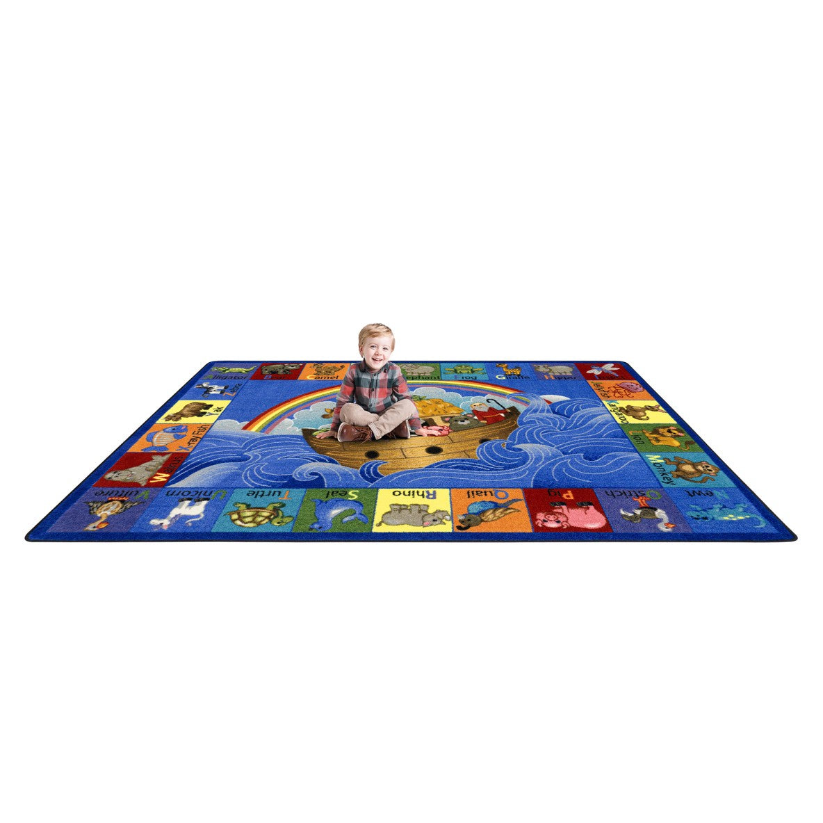 Child sitting on a colorful rug with various illustrations
