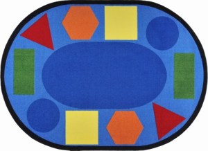 An oval classroom seating rug with fun shapes in different colors around the edge of the rug.